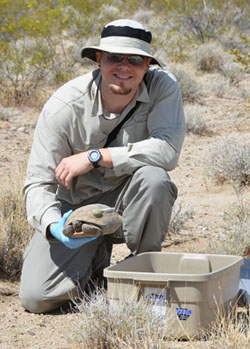 Dr. Todd with a desert tortoise in the Mojave National Preserve